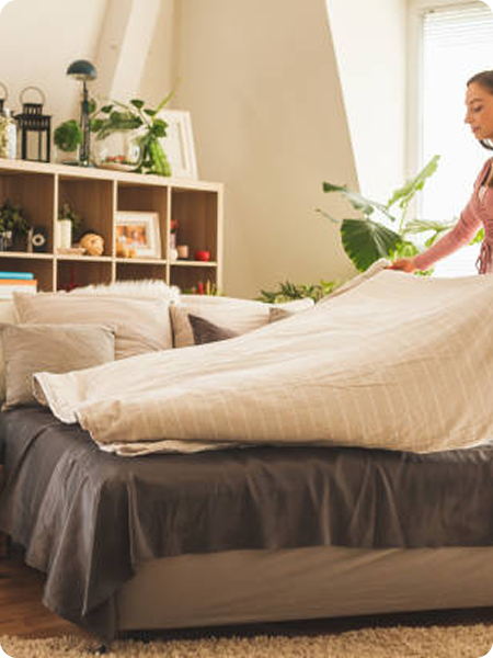 mujer-joven-haciendo-la-cama-en-casa